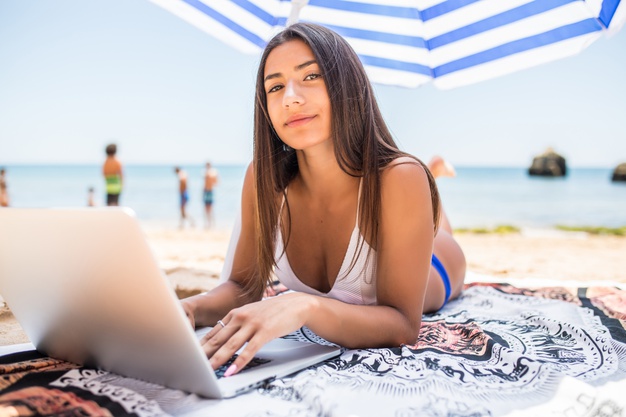Get Free Easy Fast Money Online up to $350,000 Free Online Business Beautiful-woman-working-online-laptop-while-lying-beach-sun-umbrella-near-sea-happy-smiling-freelancer-girl-relaxing-using-notebook-freelance-internet-work_231208-5329